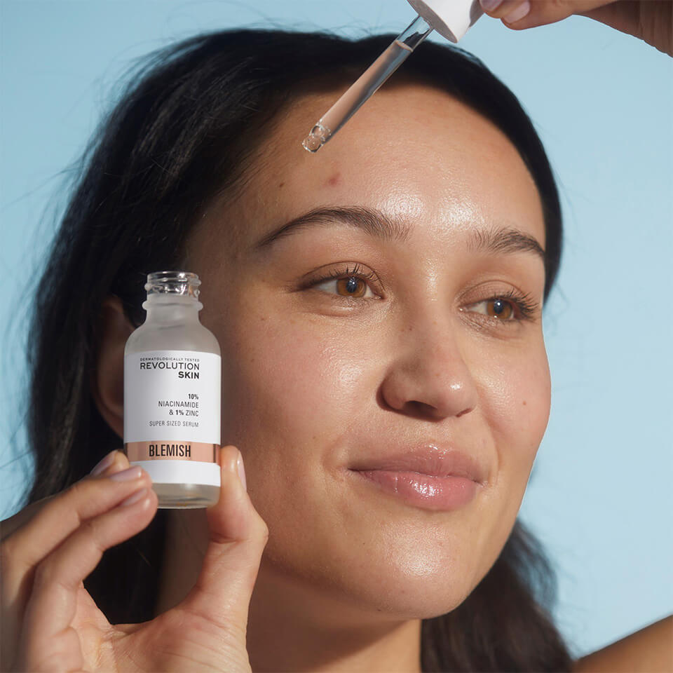 An image of Anna applying the Revolution Skincare 10% Niacinamide + 1% Zinc Blemish & Pore Refining Serum 